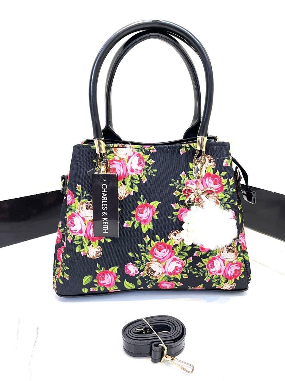 Elegant Floral Pattern Handbag with Stylish Handle and Charm Accent