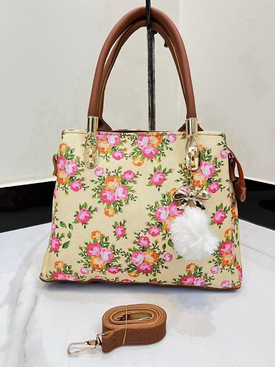 Elegant Floral Pattern Handbag with Stylish Handle and Charm Accent