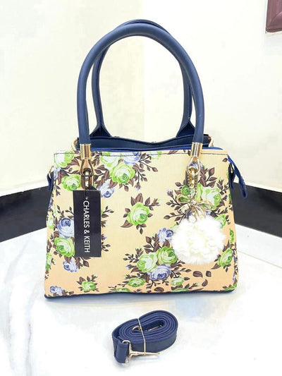 Elegant Floral Pattern Handbag with Stylish Handle and Charm Accent